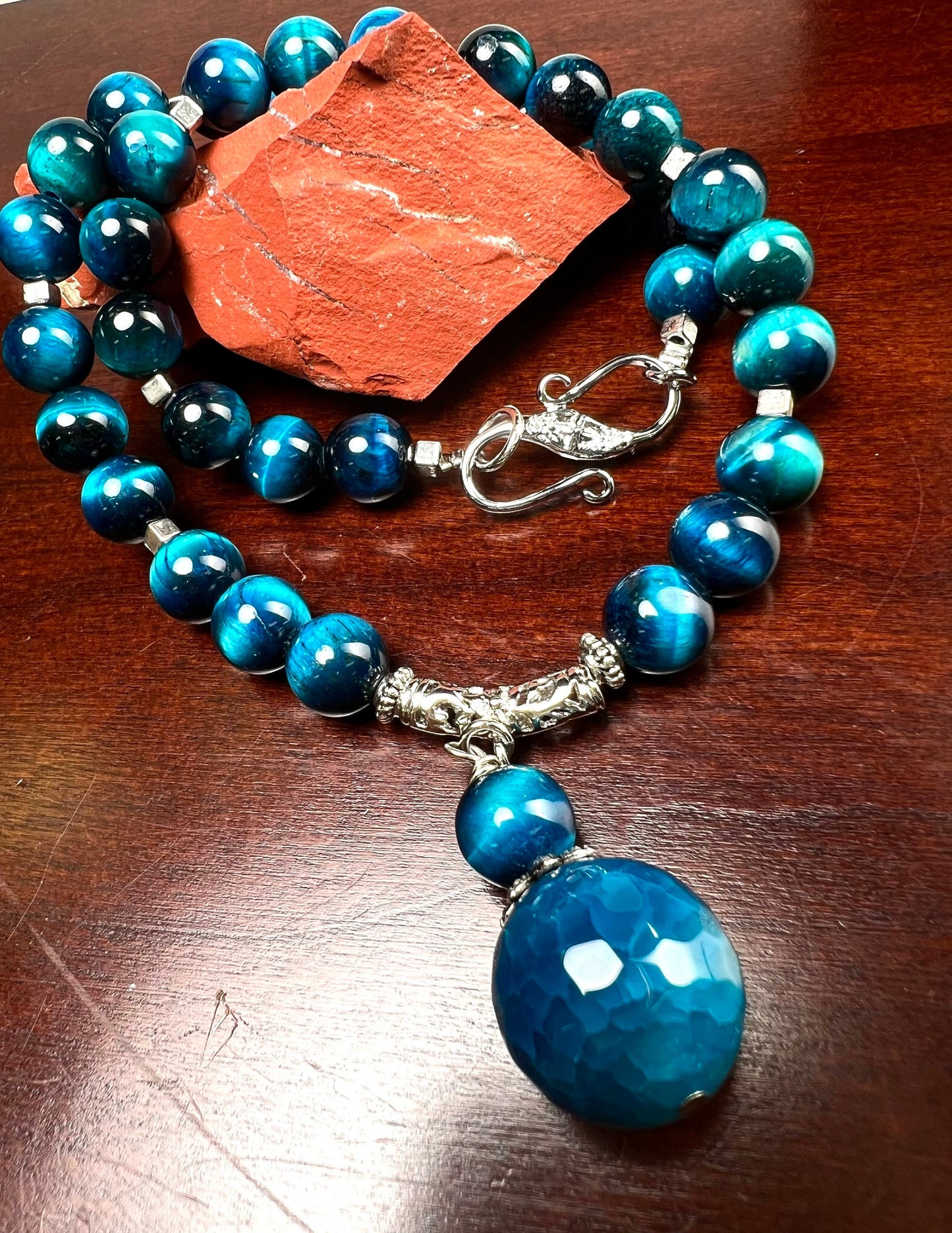 Blue Tiger Eye 8mm smooth round AAA with matching blue fire agate 18mm pendant rhodium S hook clasp 18” necklace. Energy and strength.