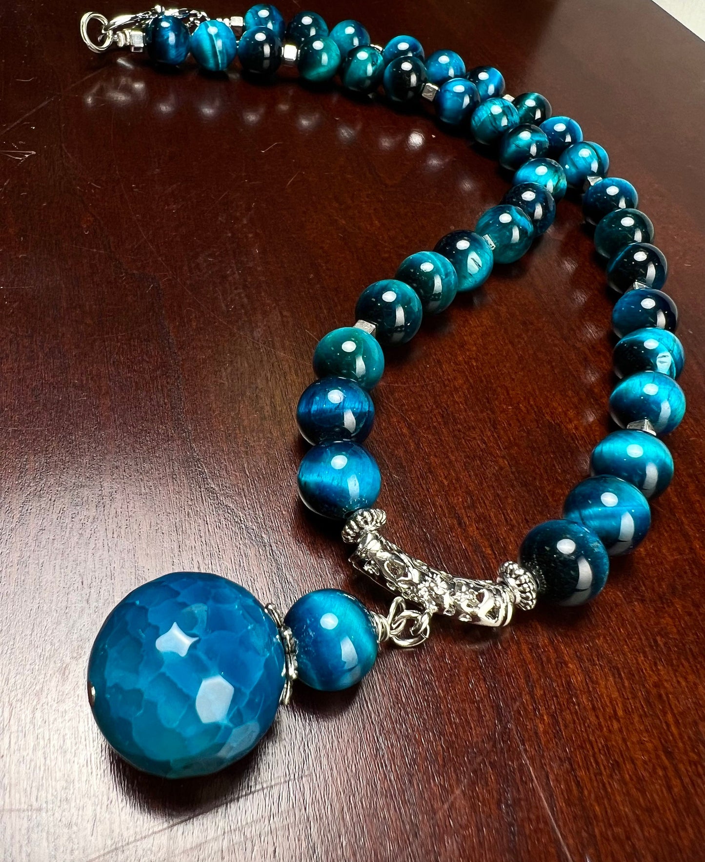 Blue Tiger Eye 8mm smooth round AAA with matching blue fire agate 18mm pendant rhodium S hook clasp 18” necklace. Energy and strength.