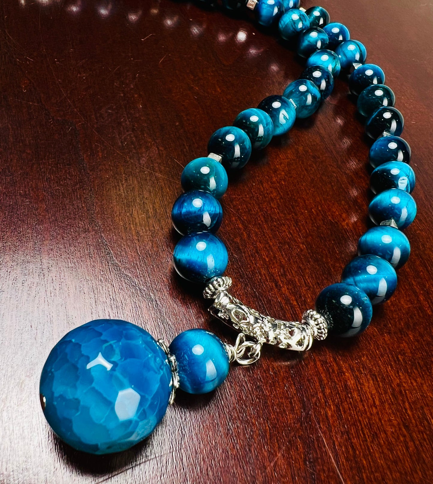 Blue Tiger Eye 8mm smooth round AAA with matching blue fire agate 18mm pendant rhodium S hook clasp 18” necklace. Energy and strength.
