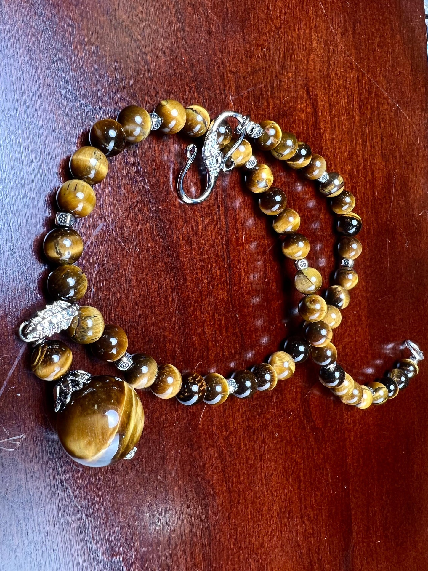 Brown Tiger Eye 8mm smooth round AAA with matching tiger eye 18mm pendant rhodium silver spacer and S hook clasp 18” necklace