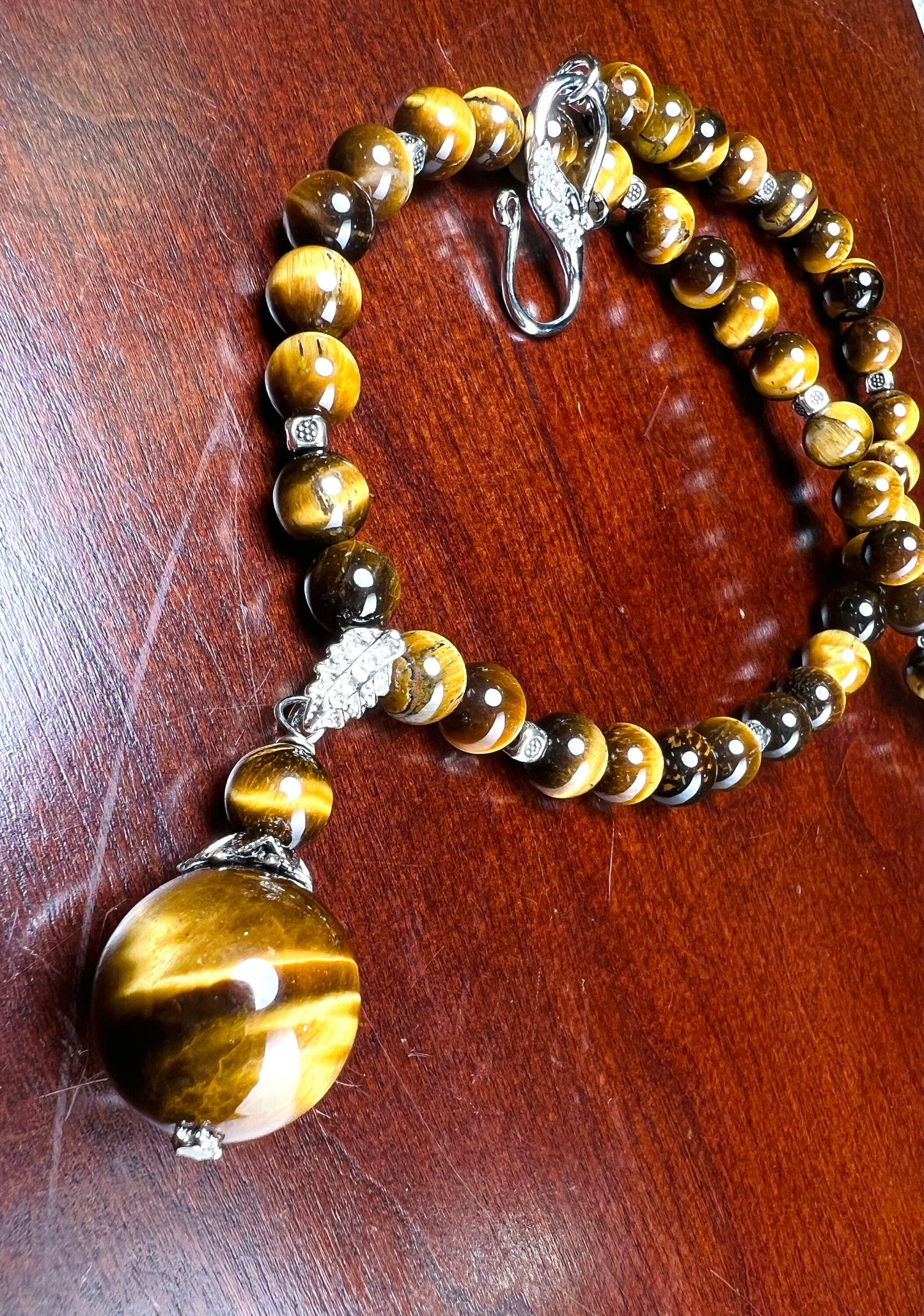 Brown Tiger Eye 8mm smooth round AAA with matching tiger eye 18mm pendant rhodium silver spacer and S hook clasp 18” necklace