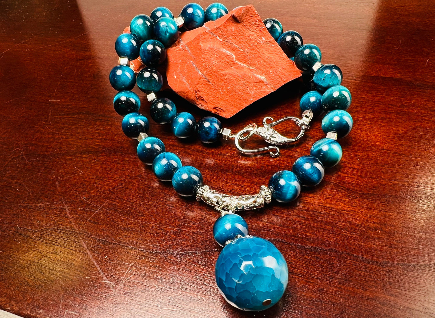 Blue Tiger Eye 8mm smooth round AAA with matching blue fire agate 18mm pendant rhodium S hook clasp 18” necklace. Energy and strength.