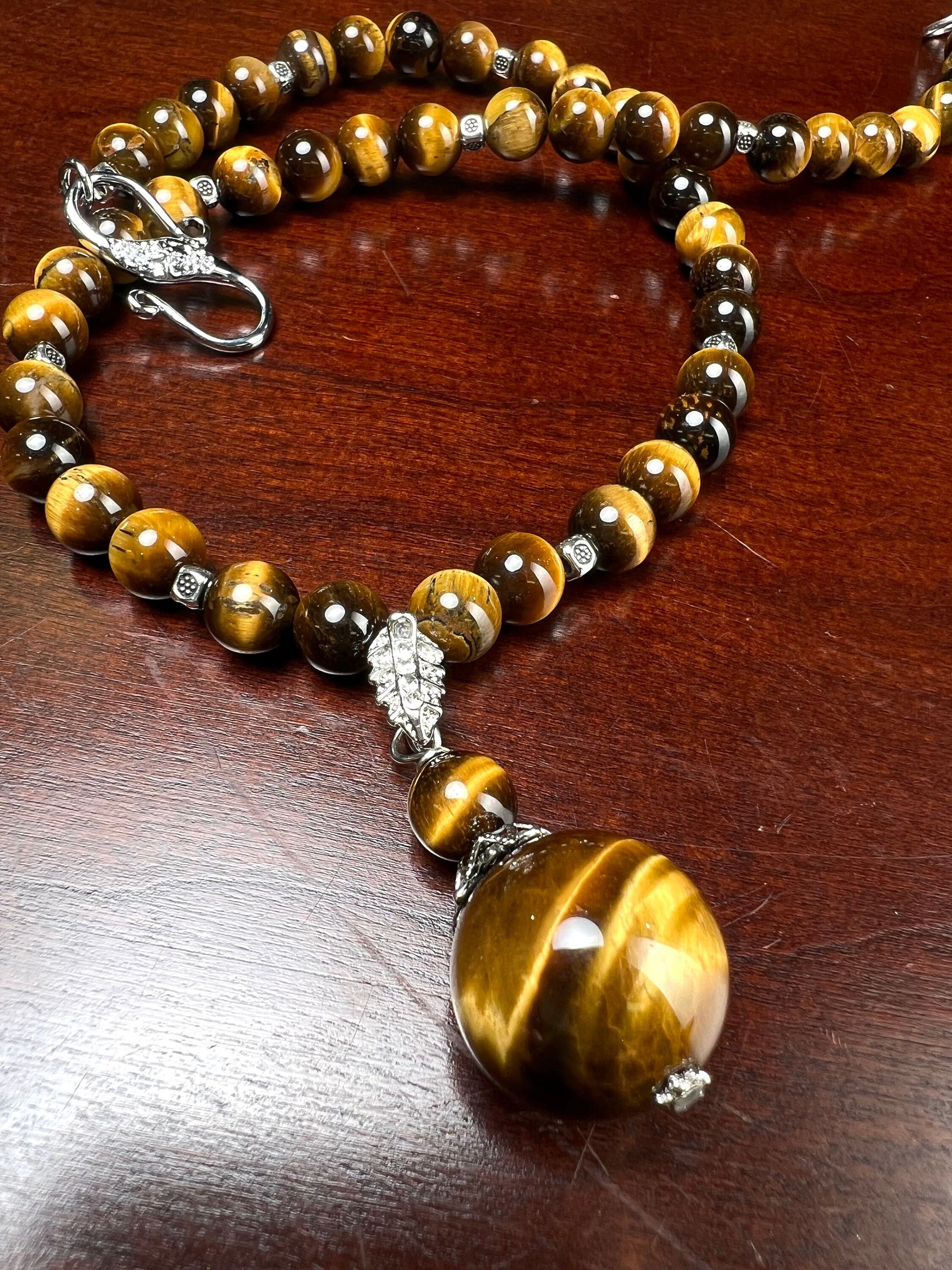 Brown Tiger Eye 8mm smooth round AAA with matching tiger eye 18mm pendant rhodium silver spacer and S hook clasp 18” necklace