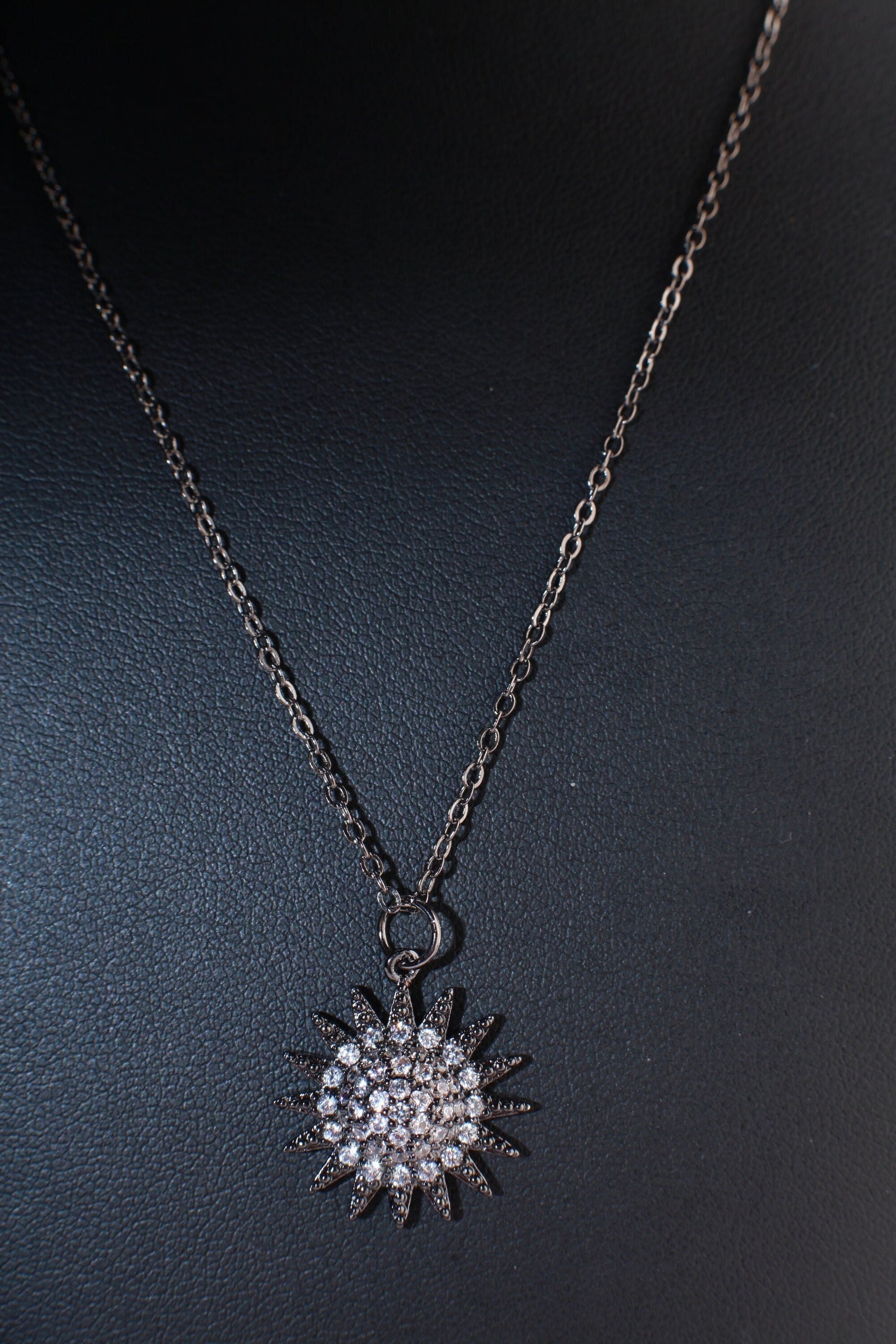 Cubic Zirconia Oxidized and Micro Pave Diamond Sun Charm Necklace. Available in 16",18" and 20"