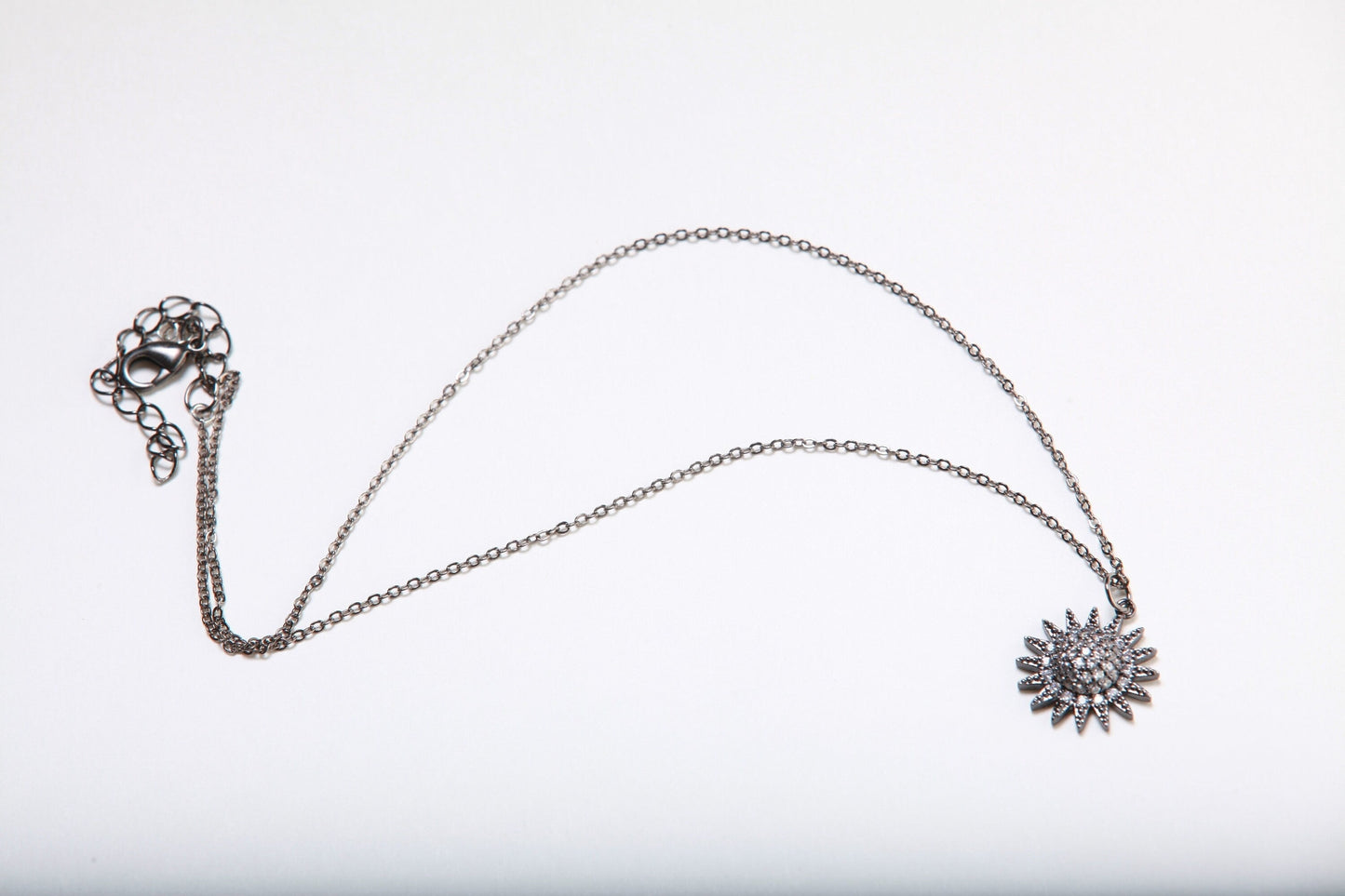 Cubic Zirconia Oxidized and Micro Pave Diamond Sun Charm Necklace. Available in 16",18" and 20"