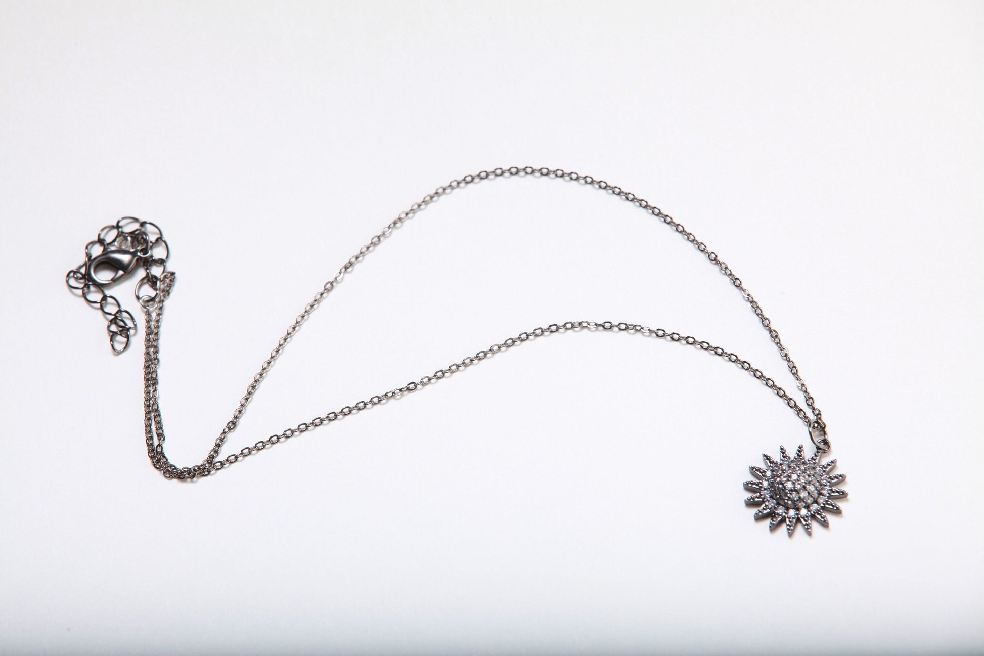Cubic Zirconia Oxidized and Micro Pave Diamond Sun Charm Necklace. Available in 16",18" and 20"