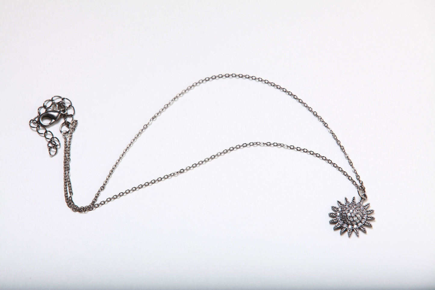 Cubic Zirconia Oxidized and Micro Pave Diamond Sun Charm Necklace. Available in 16",18" and 20"
