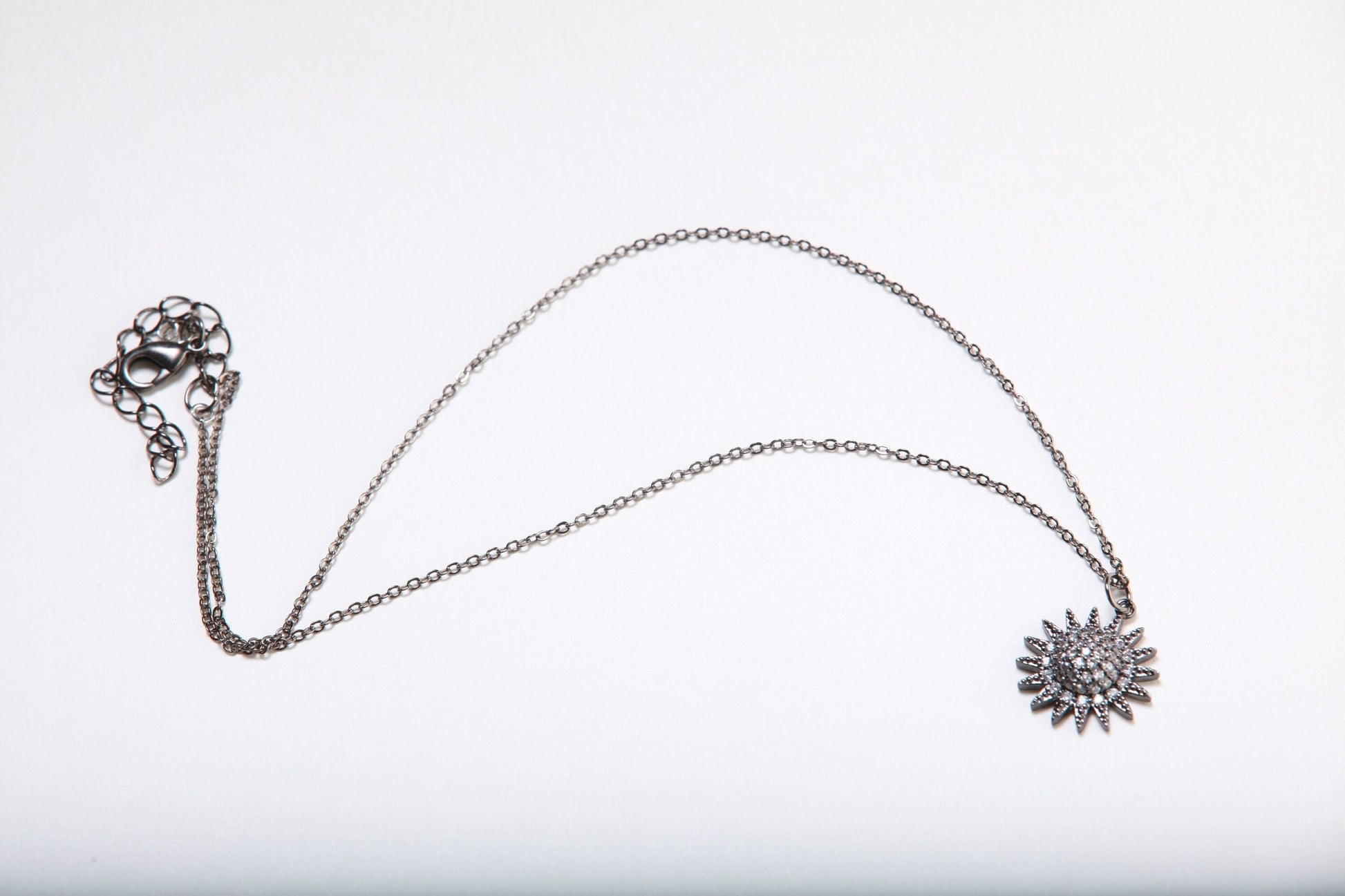 Cubic Zirconia Oxidized and Micro Pave Diamond Sun Charm Necklace. Available in 16",18" and 20"